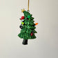 Black Cat Knocking Down Tree Wrapped in Lights