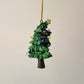 Black Cat Knocking Down Tree Wrapped in Lights
