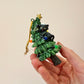 Black Cat Knocking Down Tree Wrapped in Lights